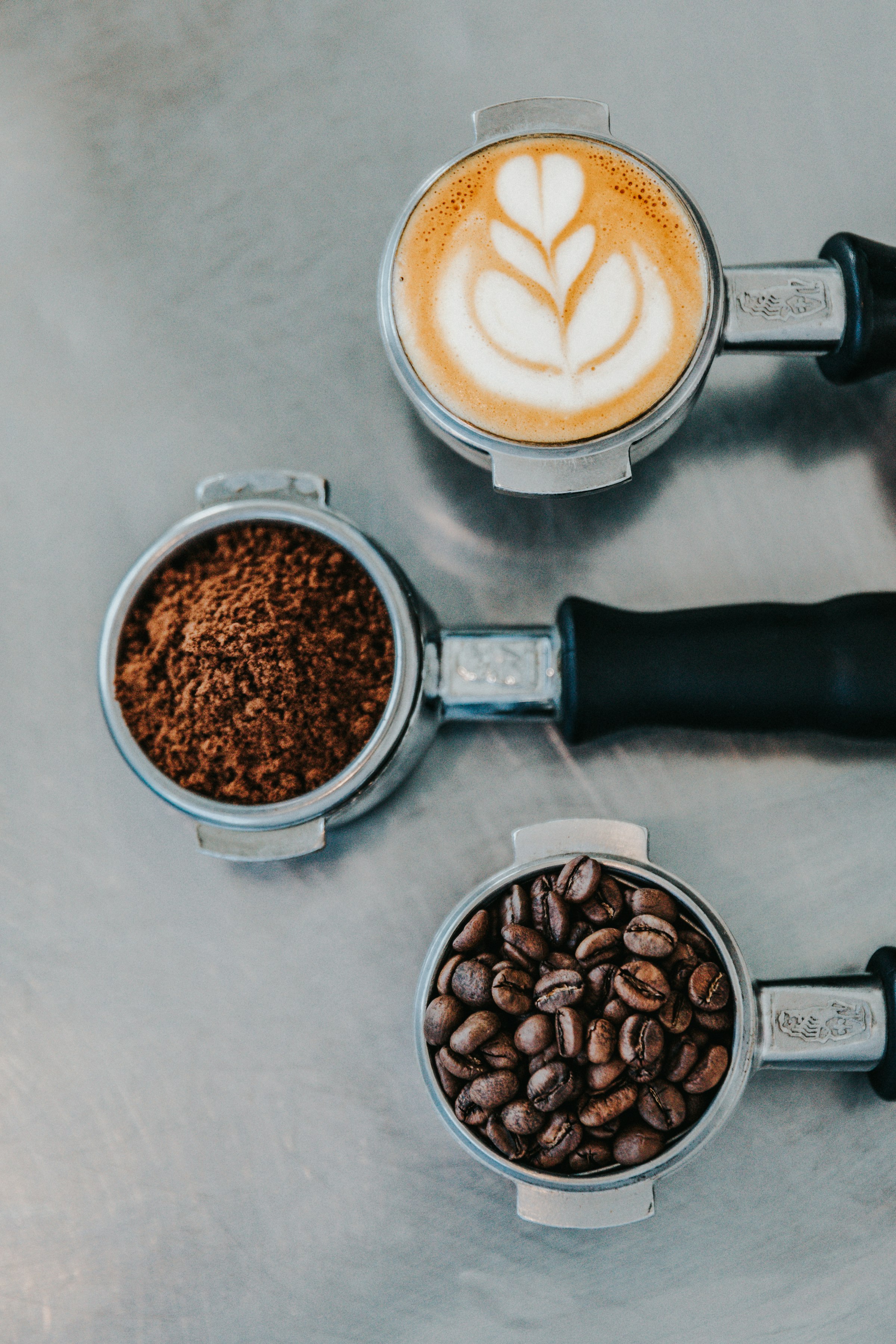 Espresso grounds and a fresh flat white on the bar